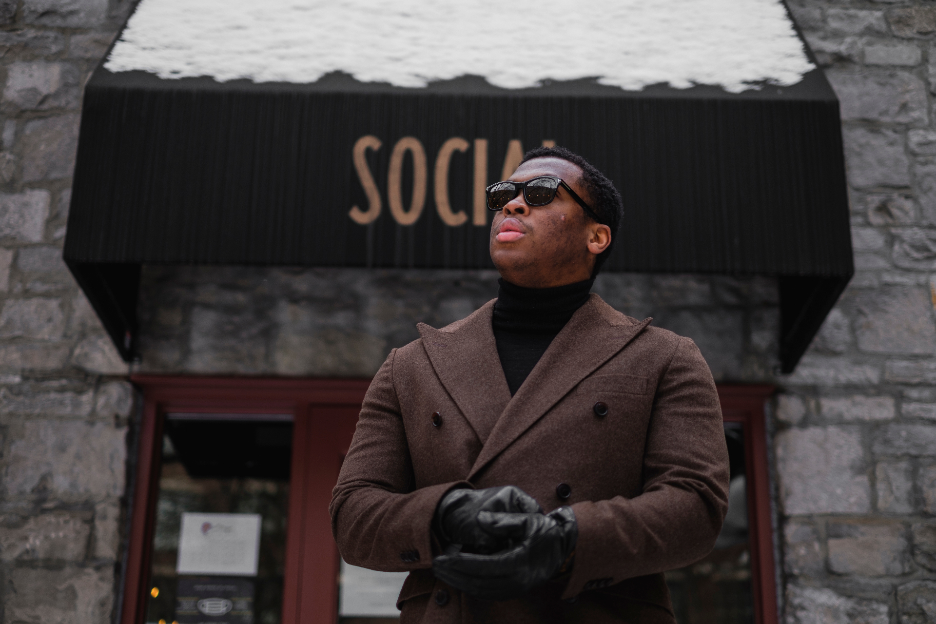 Winter street portrait in a brown overcoat outside Social