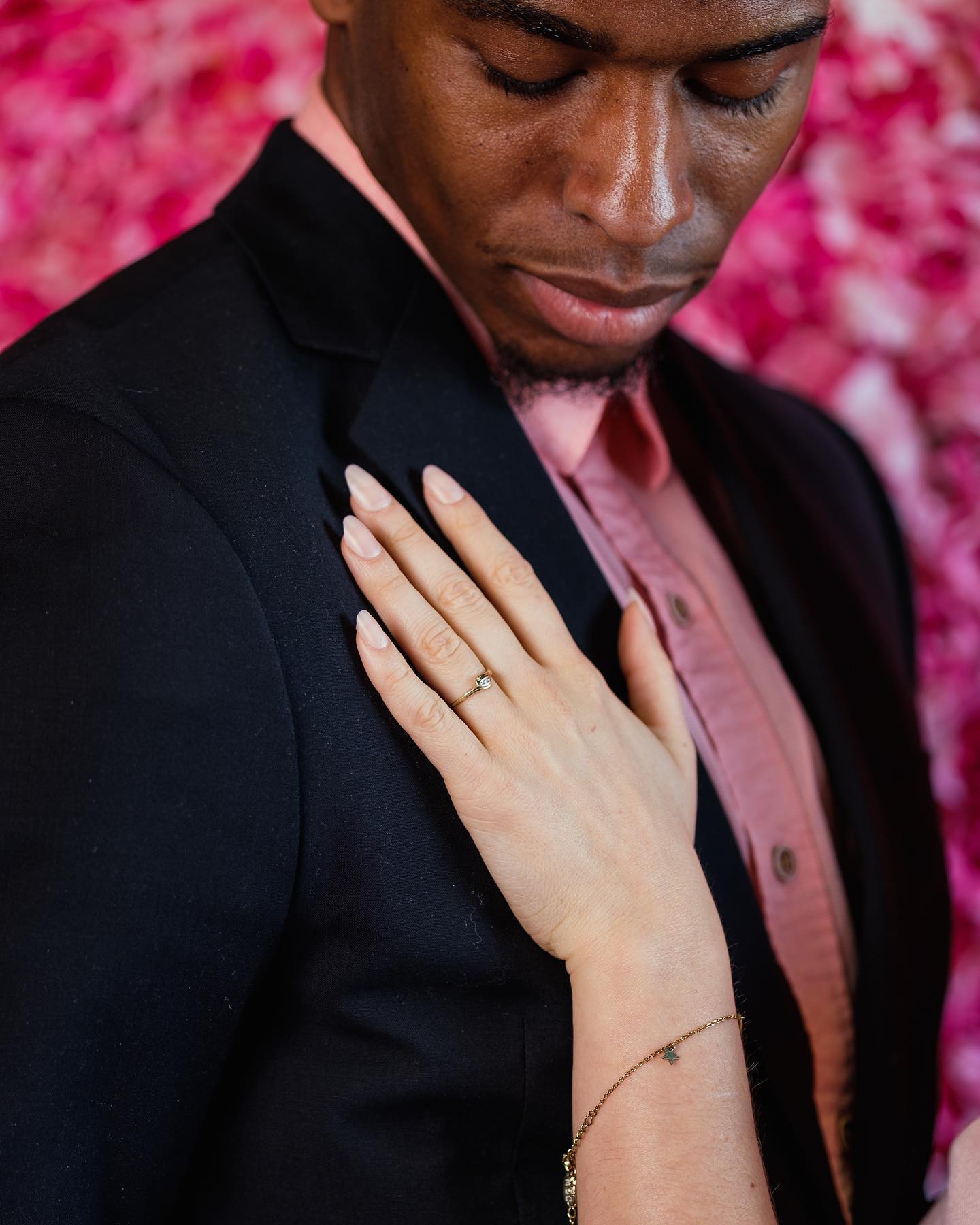 Engagement ring detail against pink florals