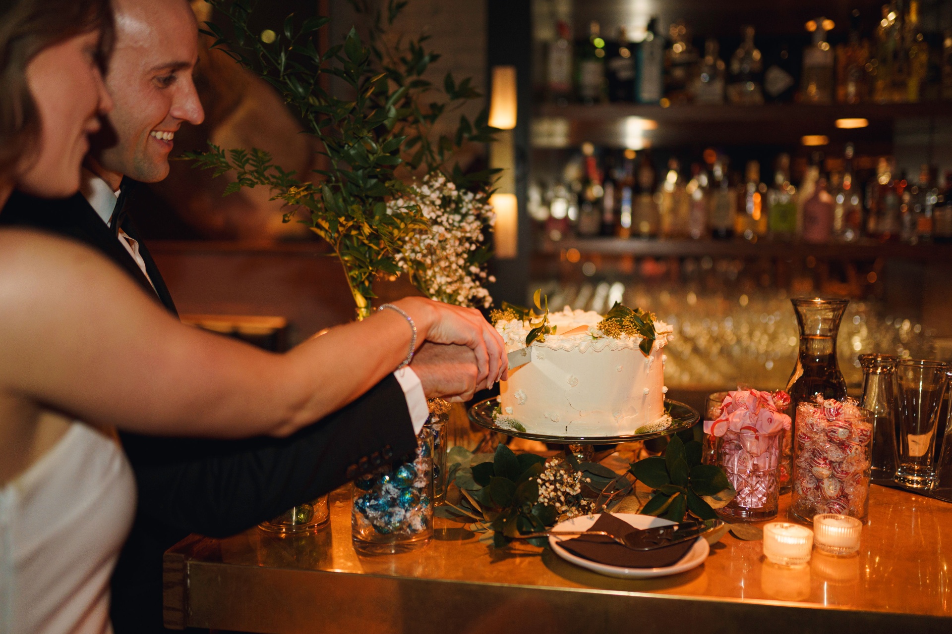 Cutting the wedding cake at the bar