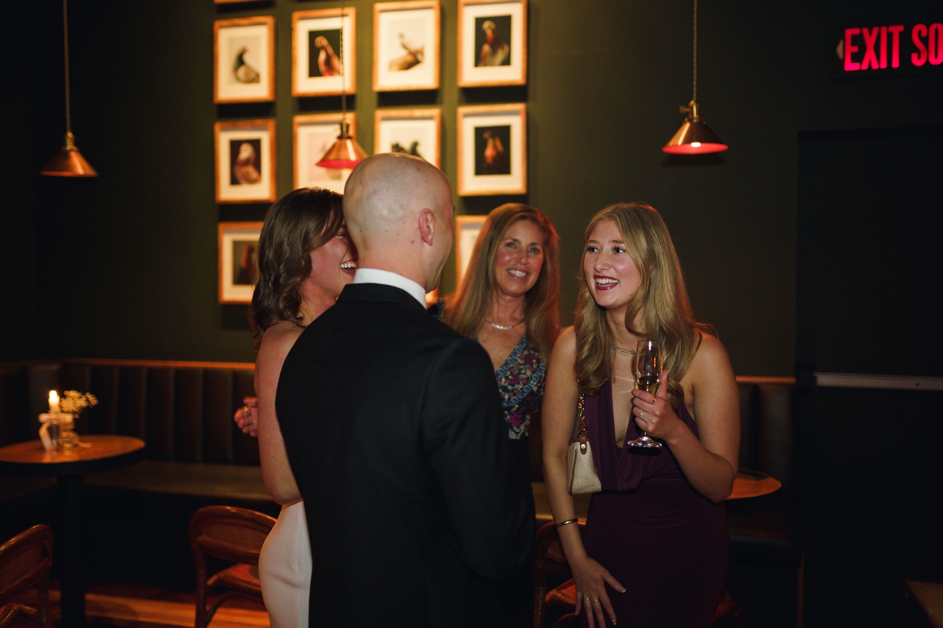 Reception conversation by the gallery wall