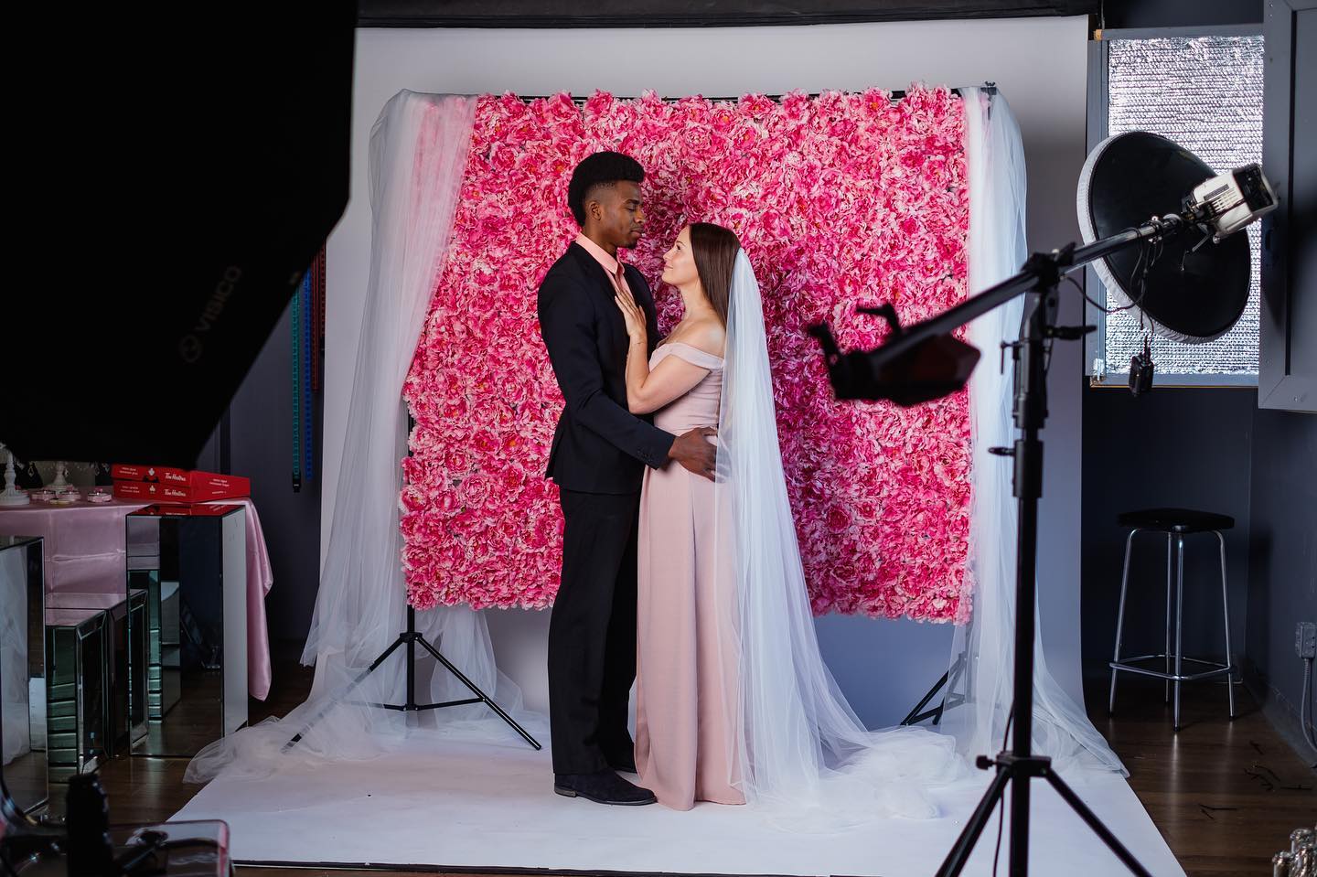 Studio bridal portrait with pink floral wall